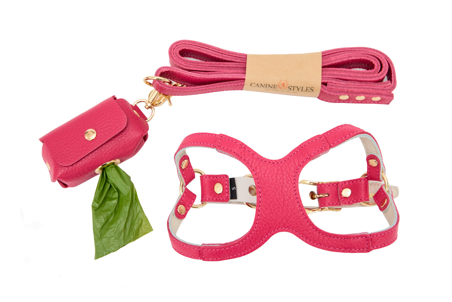 Hot pink dog harness, leash, and poop bag holder set on a white background