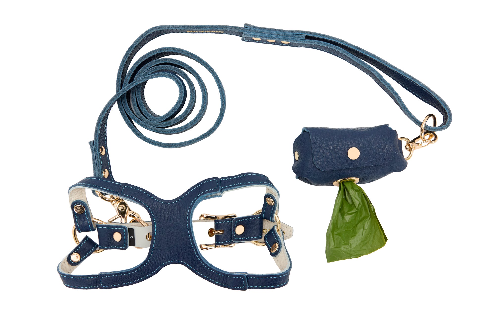 Blue leather dog harness and leash set with a poop bag holder on a white background