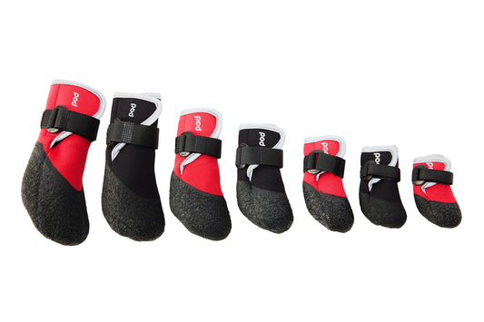 Set of red and black pet boots with straps on a white background