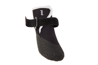 Black dog boot with a strap on a white background
