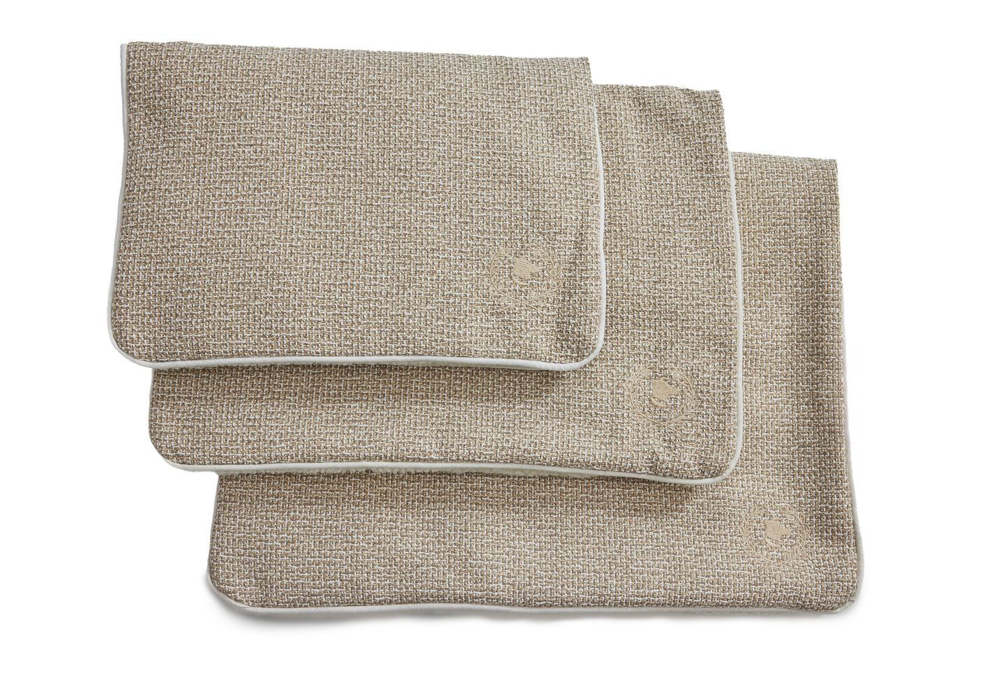 A beige crate mat made of cotton fabric and Sherpa, designed for pets, displayed in a folded manner against a white background.