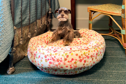 Dog sitting on a floral-patterned dog bed